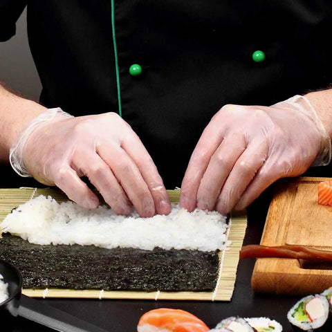 Hands using Straight Up Premium Clear Vinyl Exam Gloves Large 1000 Pack Latex Free Powder Free to prepare sushi rice.