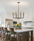 Industrial Eight Light Farmhouse Chandelier With Rustic Iron Candle Pendants above kitchen island with white cabinetry