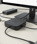 Thunderbolt 3 Travel Dock providing dual 4K screen space on an office desk, connected to laptop and monitors.