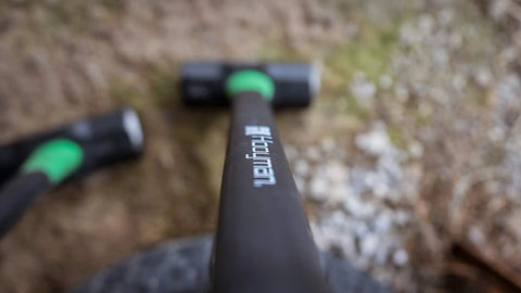 Close-up of 16 Lb Sledge Hammer With Beefy Heavy Duty Build, No Slip H Grip Handle, Fiberglass Core on ground