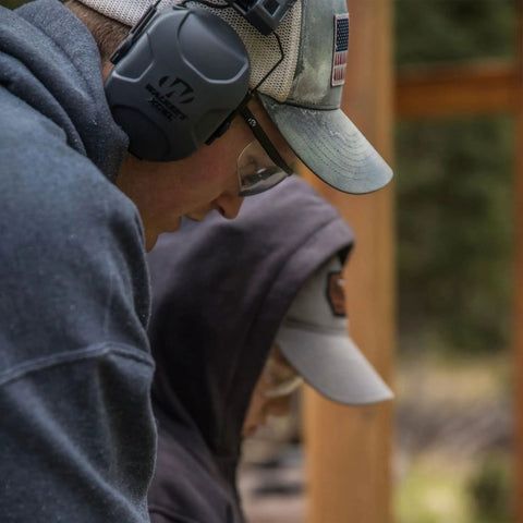 Person wearing Xcel Digital Electronic Hearing Protection Earmuffs With Bluetooth And Voice Clarity For Hunters And Range Shooters