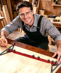 Craftsman using Built Tough Adjustable Aluminum Stair Tread Template Tool for precise measuring in carpentry.