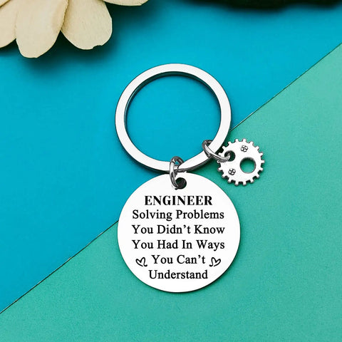 Engineer inspirational keychain on blue background, stainless steel, 30mm pendant with gear charm, keychain gift for students and pros alike a funny yet practical graduation token for mechanical civil architectural software and electrical engineers and a great teacher appreciation gift