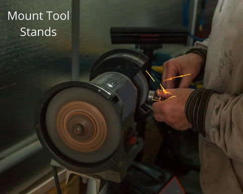 Person using a bench grinder tool with sparks flying, focusing on hands and grinding wheel in a workshop setting.