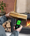 Pin Type Wood Moisture Meter With Hold Function 12mm Probes Big Backlit LCD Screen And Three Color LED Bar Graph For Easy Accurate Wood Moisture Readouts Ideal For DIY Carpentry And Home Renovation Projects. testing firewood near fireplace