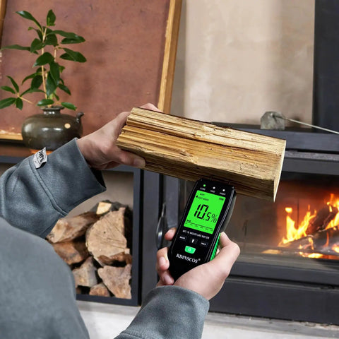 Pin Type Wood Moisture Meter With Hold Function 12mm Probes Big Backlit LCD Screen And Three Color LED Bar Graph For Easy Accurate Wood Moisture Readouts Ideal For DIY Carpentry And Home Renovation Projects. testing firewood near fireplace