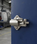 Spring Latch Lock for Cabinets and Windows, Zinc Alloy Self Closing Bolt Latch installed on a blue door in a workshop.