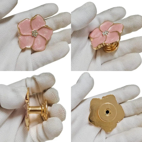 Legit Gorgeous Gold Floral Cabinet Knobs With Sparkling Rhinestone Center 5 Petal Pearlescent Enamel Dresser Pulls in hand view.