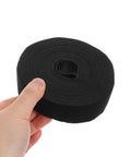 Reusable Black Polyester Cable Ties For Desk Wire Management Heavy Duty Cord Straps For Computer Setup Electronic Organizer held in hand