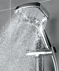 Chrome handheld shower head with hose and adjustable arm mount displaying ultra wide coverage full bodied waterfall spray.