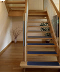Wooden stairs with Non Slip Carpet Stair Treads Set Of 15 Navy Blue 8x27 Inches Skid Resistant Rubber Backing for safe steps.