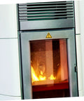 Close-up of chimney with caution sign above the fire chamber, showcasing equipment safety in busy factory work areas.