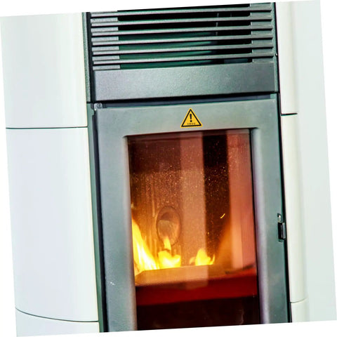 Close-up of chimney with caution sign above the fire chamber, showcasing equipment safety in busy factory work areas.