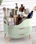 Slick Green Makeup Organizer With Two Deep Drawers And Sturdy Carry Handle, Large Skincare Storage Box on a vanity, filled with cosmetics.
