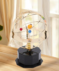 Gold Tone Solar System Model Decoration with Iron and Plastic Grand Orrery on a wooden desk by a window