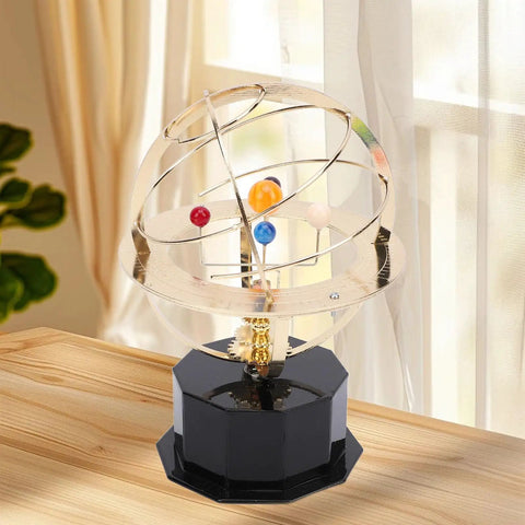 Gold Tone Solar System Model Decoration with Iron and Plastic Grand Orrery on a wooden desk by a window