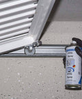Hand applying Grease-Free Dry PTFE Lubricant Spray For Metal, Plastic And Wood Surfaces on a metal hinge, silicone free, 13.5 oz can.