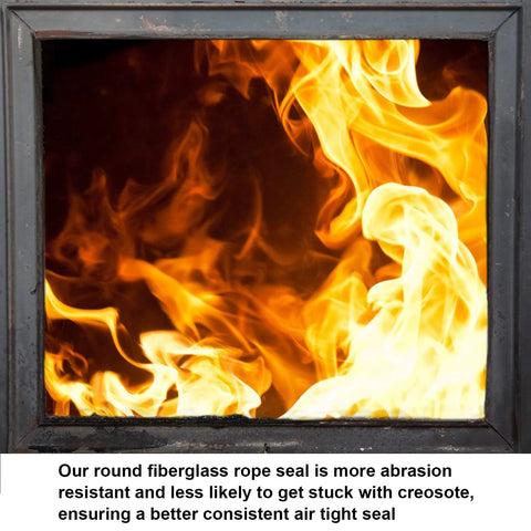 Wood stove door with glass window showing bright orange flames inside