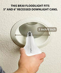 Hand holding BR30 Zigbee Smart Bulbs 6 Pack Dimmable Flood Light Soft White 2700K showing recessed fixture fitting
