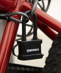 40mm Laminated Steel Weather Resistant Padlock With 2 Inch Shackle Vinyl Wrapped Chrome Plated Hardened Steel Body securing a bicycle