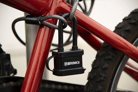 40mm Laminated Steel Weather Resistant Padlock With 2 Inch Shackle Vinyl Wrapped Chrome Plated Hardened Steel Body securing a bicycle