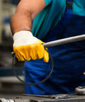 Person holding a black rubber belt with yellow glove for 2 Pack Industrial Rubber Belts For Continuous Sealing Machines And Auto Sealers Tough As Nails Wear Resistant Replacement Guide Transport Belt No Sweat Install.