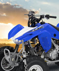 Heavy Duty Ratchet Tie Down Straps 15 Foot 4 Pack Featuring Tough As Nails Grip With 2200 Pound Break Strength to secure a blue ATV at sunset.