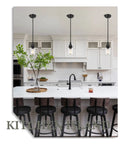 2 Pack Black Pendant Light Set With Wine Glass Shade illuminating modern kitchen with island and dining room seating.