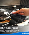 Person using Bulk 50 Pack Microfiber Cleaning Cloths 11.5 By 11.5 Inches Lint Free Reusable Towels to clean stove spills