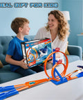 Child receiving Shark Themed Car Race Track Set With Dual Loop And 2 Cars And Launchers, playset on table