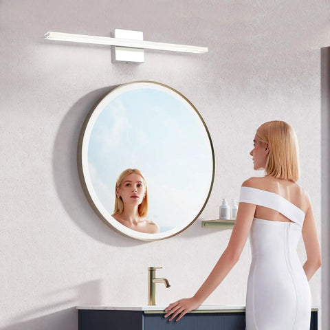 Chrome Bathroom Light Fixtures 24 Inch LED Vanity Bar Over Mirror Lighting IP44 Waterproof 14W 850LM Modern Rectangle Vanity Lamp For Bathroom Acrylic Restroom Sink Light mounted above a round mirror with a woman looking in.