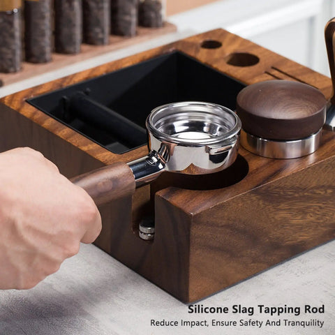 Hand holding a portafilter over the Top Shelf Natural Walnut Espresso Knock Box And Tamp Station, Removable Stainless Steel Grounds Holder.