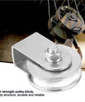 Heavy Duty Snatch Block Pulley Wheel For Wire Rope Lifting 0.3 Ton Capacity Single Rigging Block With Swivel Hoist For Lifting Plants Tools And Small Furniture To Elevated Spots. Silver metal pulley block with wire rope in use