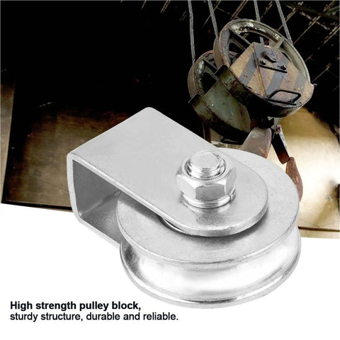 Heavy Duty Snatch Block Pulley Wheel For Wire Rope Lifting 0.3 Ton Capacity Single Rigging Block With Swivel Hoist For Lifting Plants Tools And Small Furniture To Elevated Spots. Silver metal pulley block with wire rope in use