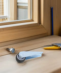 Close-up of Rock Solid Sliding Door Rollers With Durable Rubber Casters on a wooden surface for barn doors and closets.