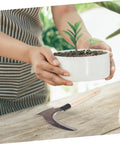 All In One Multi Functional Gardening Weeding Tool With Dual Blade Manganese Hook Portable on wooden table near potted plant