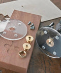 Damn Solid Brass Router Bushing Guide Set With Eight Precision Template Guides Lock Nuts And Compact Case for woodrouting tools on a workbench