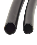 Close-up view of black polyethylene half inch drip irrigation tubing for garden systems.