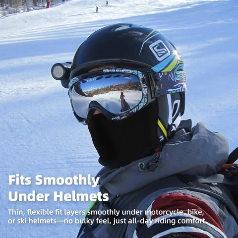 Person wearing All Season Balaclava Face Mask For Men And Women With UPF 50 Plus UV Protection under ski helmet on snow slope.