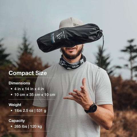 Man holding Ultralight Backpacking Camp Chair That Packs Smaller Than a Water Bottle, Weighs Just 1.1 Lbs