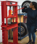 Person operating 20 Ton Hydraulic Shop Press For Gear Bearing And Bushing Removal Straightening And Bending Heavy Duty Industrial Grade Beast With 8.5 Inch Stroke Bottle Jack Reinforced Head Plate Built For Pros