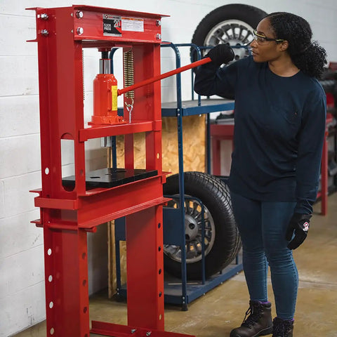 Person operating 20 Ton Hydraulic Shop Press For Gear Bearing And Bushing Removal Straightening And Bending Heavy Duty Industrial Grade Beast With 8.5 Inch Stroke Bottle Jack Reinforced Head Plate Built For Pros