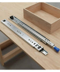 High Octane Heavy Duty Side Mount Ball Bearing Drawer Slides With Triple Extension Full Reach Cold Rolled Steel cabinet rails on a table.