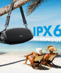 Monster Bass 120W Outdoor Bluetooth Speaker Boombox With IPX6 Waterproof Build hanging from palm tree on beach