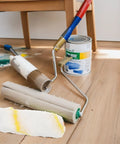 Heavy Duty Polyester Paint Roller Cover Refills and tools on wooden floor for easy ceiling and wall painting.