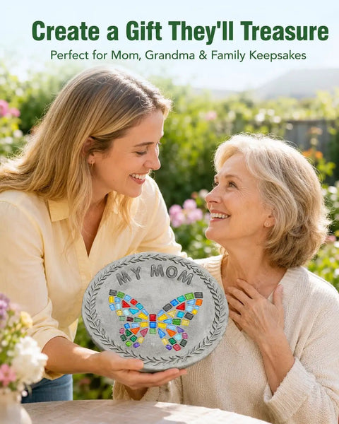 Mother and daughter holding a personalized DIY stepping stone with mosaic tiles and 'My Mom' text, in a garden setting.