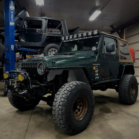Green off-road vehicle with XLK Series Linkable Mounting Brackets Kit for LED light bars on roof, rugged tires.