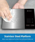 Smart Digital Kitchen Scale with 23 Nutrients Tracking being wiped clean, showing stainless steel surface, 11 lb capacity.