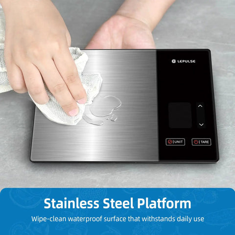 Smart Digital Kitchen Scale with 23 Nutrients Tracking being wiped clean, showing stainless steel surface, 11 lb capacity.