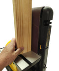 Heavy Duty 4 By 36 Belt And 8 Inch Disc Sander With 7 Amp Motor, user holding wood near sanding surface.